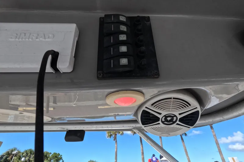 Slide: The Image of 2012 Robalo R247 Dual Console boat dashboard with switches and speaker. - 82