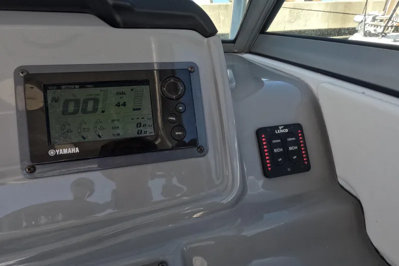 Slide: The Image of 2012 Robalo R247 Dual Console dashboard with Yamaha display and Lenco controls. - 89