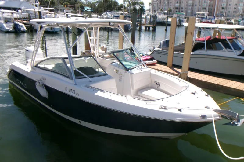 Slide: The Image of 2012 Robalo R247 Dual Console boat docked in marina, sunny day. - 9