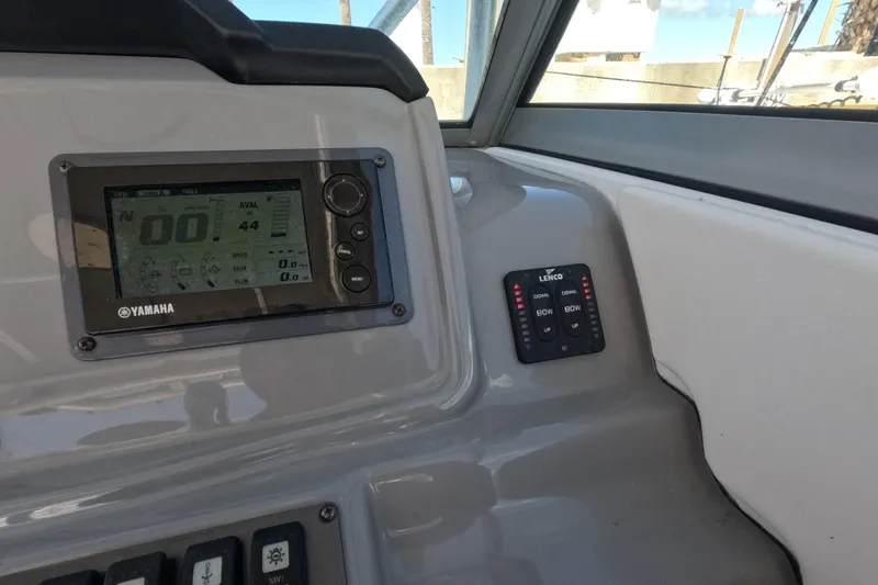 Slide: The Image of 2012 Robalo R247 Dual Console boat docked in marina. - 90