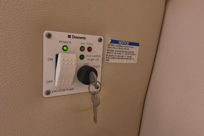 Slide: The Image of 2012 Robalo R247 Dual Console boat interior with seating and covered engine. - 98