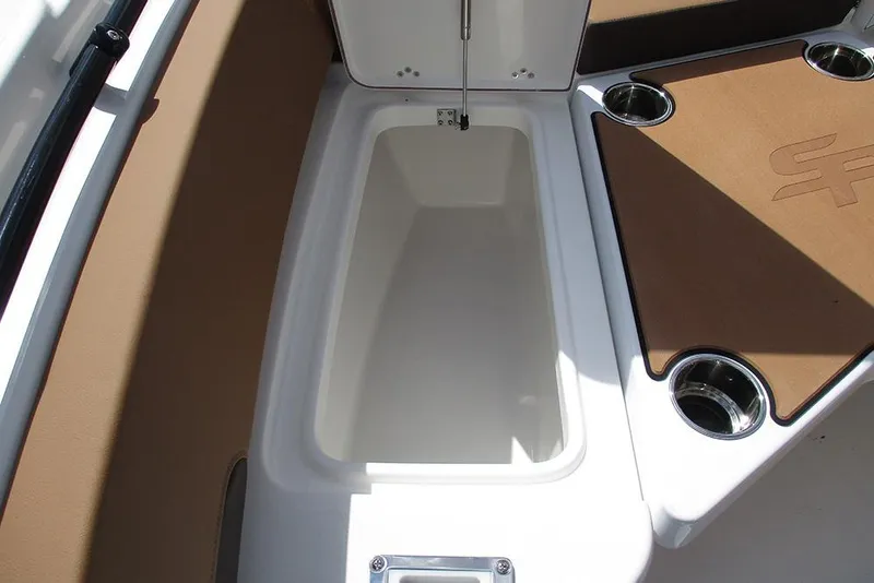 Slide: The Image of 2026 Sea Pro 225FLX Sandbar boat storage compartment with cup holders. - 11