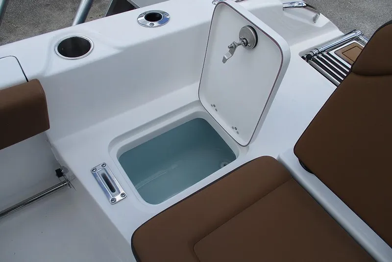 Slide: The Image of Open storage compartment on 2026 Sea Pro 225FLX Sandbar boat with brown seating. - 17