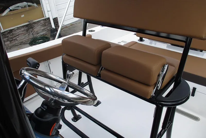 Slide: The Image of 2026 Sea Pro 225FLX Sandbar boat helm with brown seating and stainless steel steering wheel. - 20
