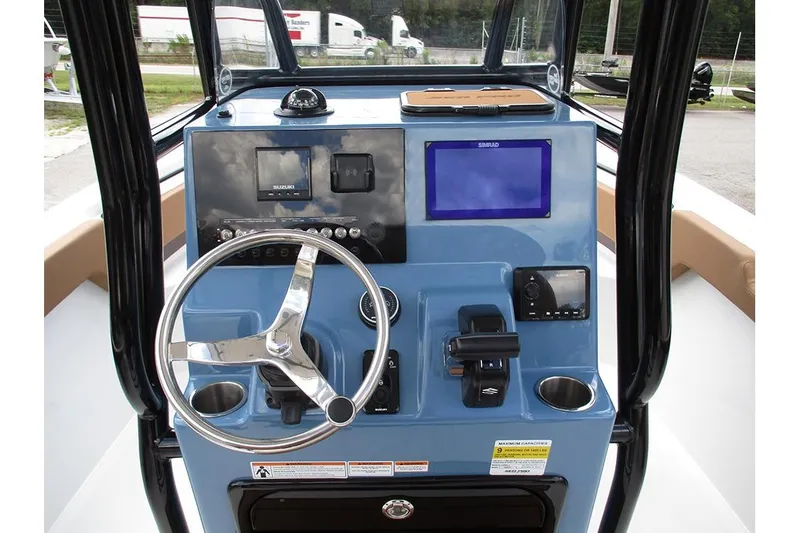 Slide: The Image of 2026 Sea Pro 225FLX Sandbar boat dashboard with steering wheel and navigation controls. - 22