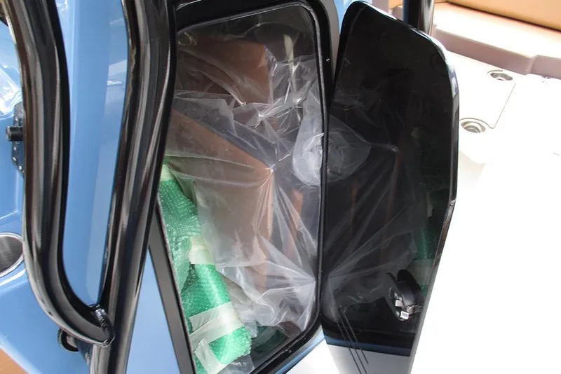Slide: The Image of Open storage compartment on 2026 Sea Pro 225FLX Sandbar boat with protective packaging inside. - 27