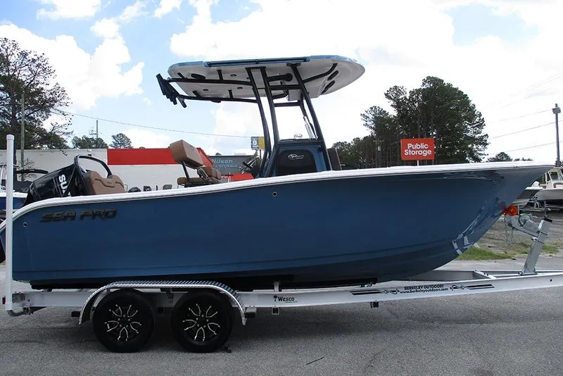 Slide: The Image of 2026 Sea Pro 225FLX Sandbar boat on trailer, blue hull, outdoor setting. - 5