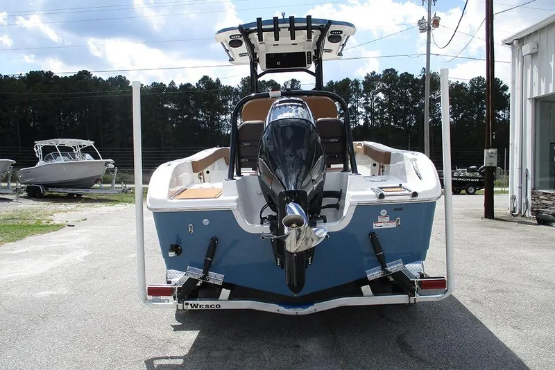 Slide: The Image of 2026 Sea Pro 225FLX Sandbar boat, rear view with outboard motor, parked outdoors. - 7