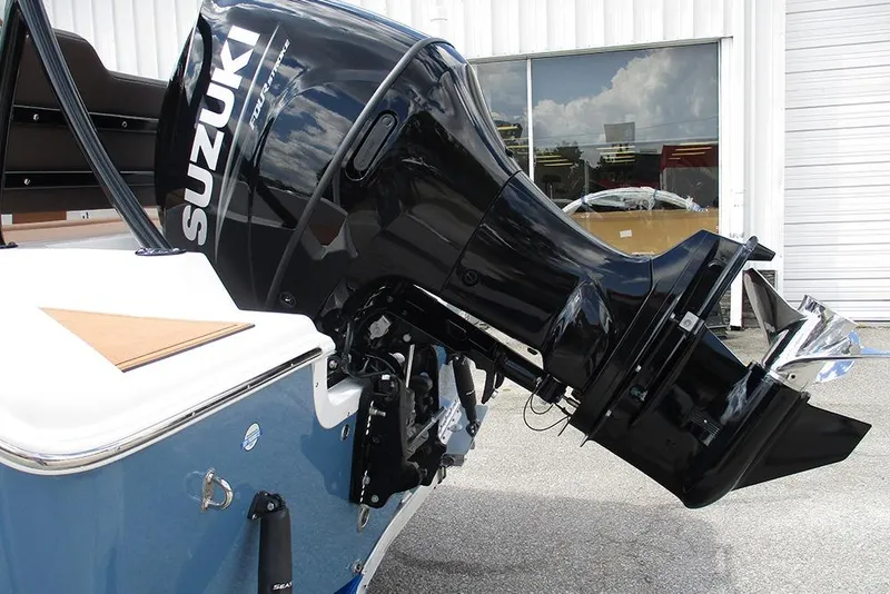 Slide: The Image of 2026 Sea Pro 225FLX Sandbar with Suzuki outboard motor, parked outdoors. - 8