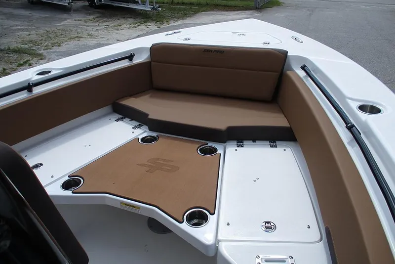Slide: The Image of 2026 Sea Pro 225FLX Sandbar boat interior with brown seating and cup holders. - 9
