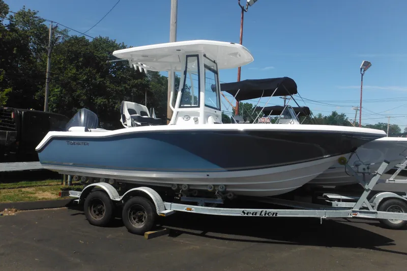 The Image of 2026 Tidewater 210 LXF boat on trailer, parked outdoors under clear sky. - 0