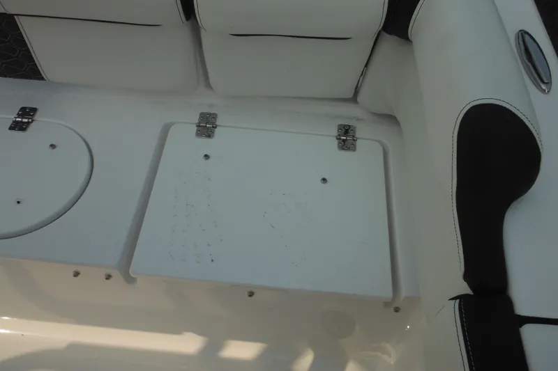 Slide: The Image of 2026 Tidewater 210 LXF boat interior with white seating and storage compartments. - 18