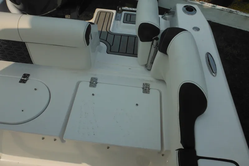 Slide: The Image of 2026 Tidewater 210 LXF boat interior with white and black seating. - 19