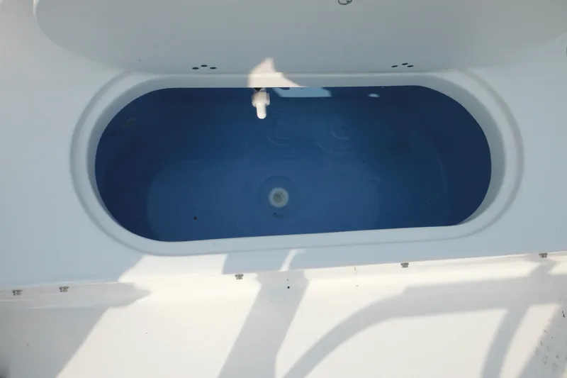 Slide: The Image of Livewell on 2026 Tidewater 210 LXF boat, featuring a blue interior. - 23