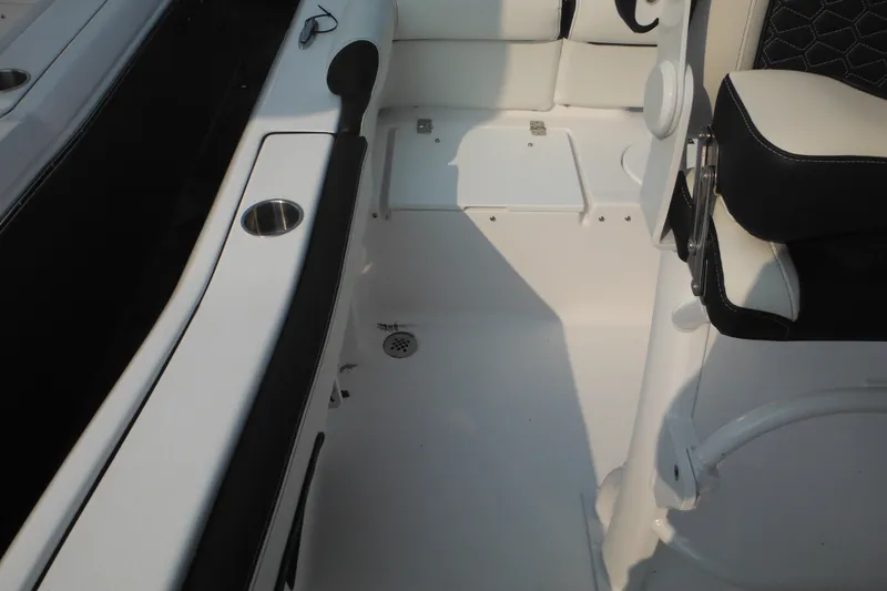 Slide: The Image of 2026 Tidewater 210 LXF boat interior with seating and cup holder. - 27