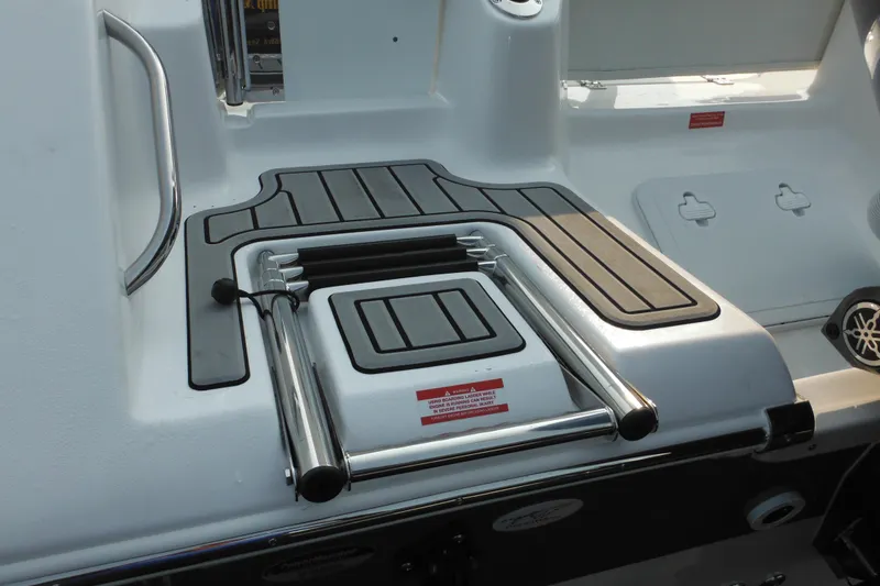 Slide: The Image of 2026 Tidewater 210 LXF boat swim platform with retractable ladder and non-slip surface. - 3