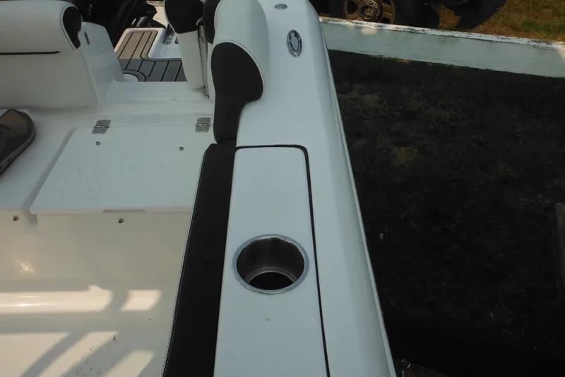 Slide: The Image of 2026 Tidewater 210 LXF boat interior with cup holder and seating detail. - 31