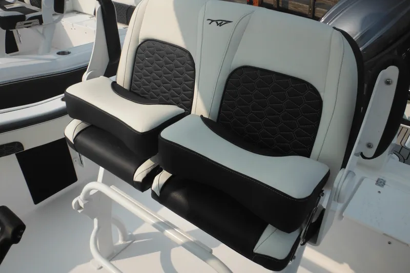 Slide: The Image of 2026 Tidewater 210 LXF boat seats with black and white cushioned design. - 33