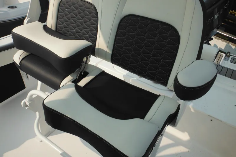 Slide: The Image of 2026 Tidewater 210 LXF boat seats with black and white upholstery, featuring armrests and stitching. - 34