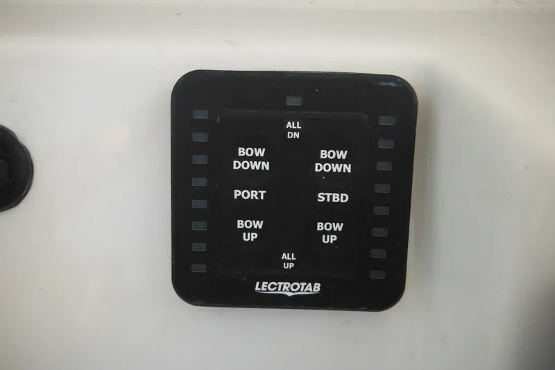 Slide: The Image of Control panel of a 2026 Tidewater 210 LXF boat with Lectrotab trim tab switches. - 41