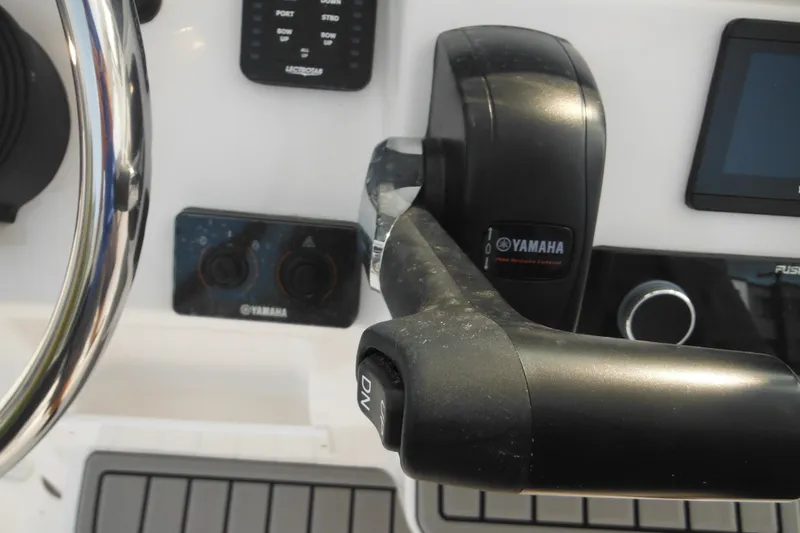 Slide: The Image of Control panel of 2026 Tidewater 210 LXF boat with Yamaha throttle and steering wheel. - 42