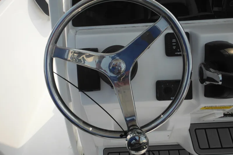 Slide: The Image of Steering wheel of 2026 Tidewater 210 LXF boat, featuring modern controls and sleek design. - 44