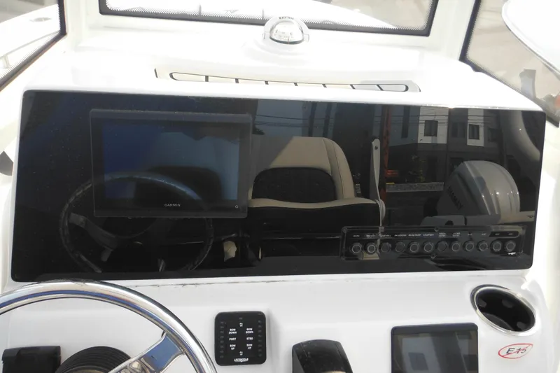 Slide: The Image of 2026 Tidewater 210 LXF boat dashboard with Garmin display and control panel. - 45