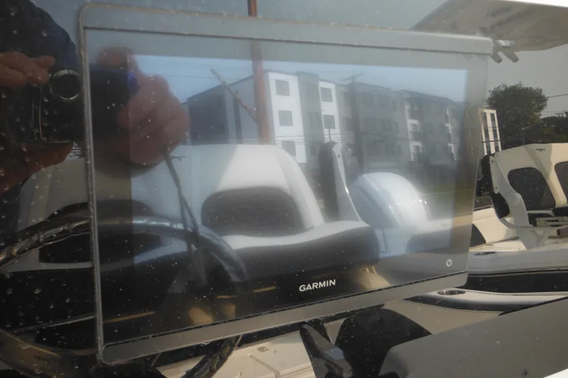 Slide: The Image of Reflection on Garmin screen inside 2026 Tidewater 210 LXF boat cockpit. - 46