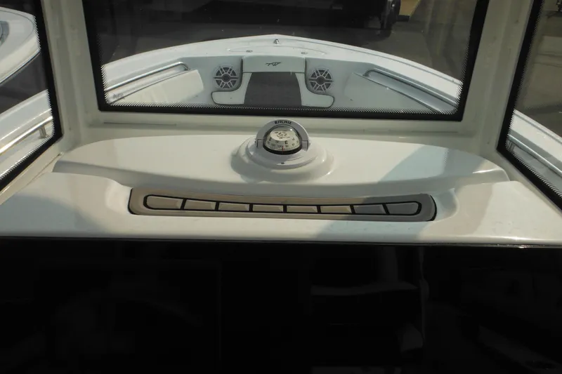 Slide: The Image of 2026 Tidewater 210 LXF boat dashboard with compass and speaker system. - 47