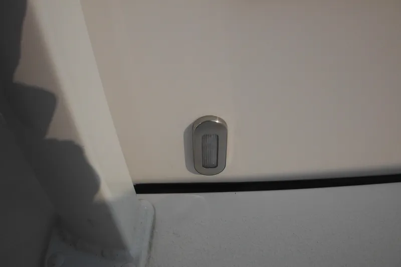 Slide: The Image of 2026 Tidewater 210 LXF boat detail, featuring a sleek, modern light fixture. - 56