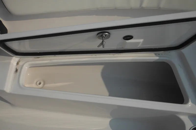Slide: The Image of Storage compartment of 2026 Tidewater 210 LXF boat, featuring secure lock and drainage. - 71