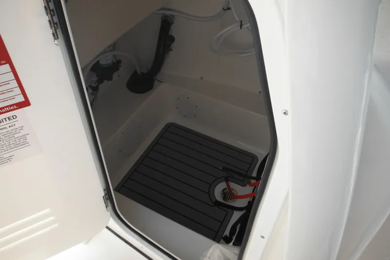 Slide: The Image of Interior view of 2026 Tidewater 210 LXF boat compartment with open door. - 74