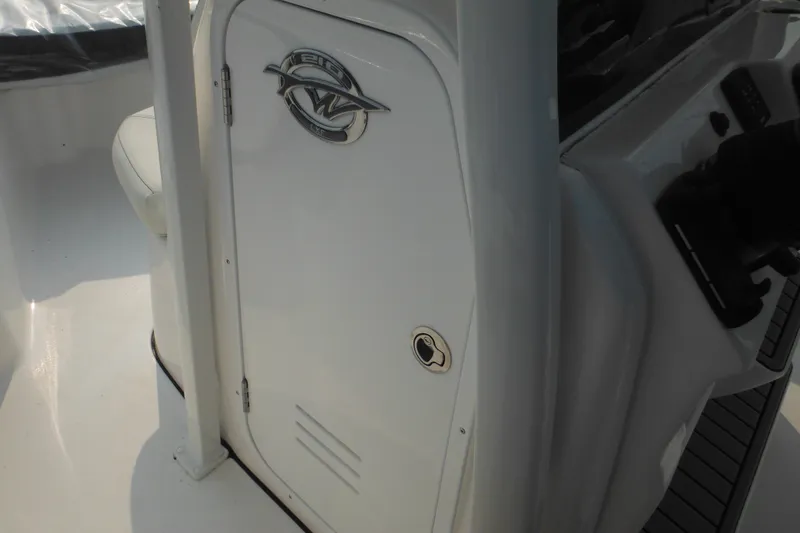 Slide: The Image of 2026 Tidewater 210 LXF boat console with storage compartment and sleek design. - 79