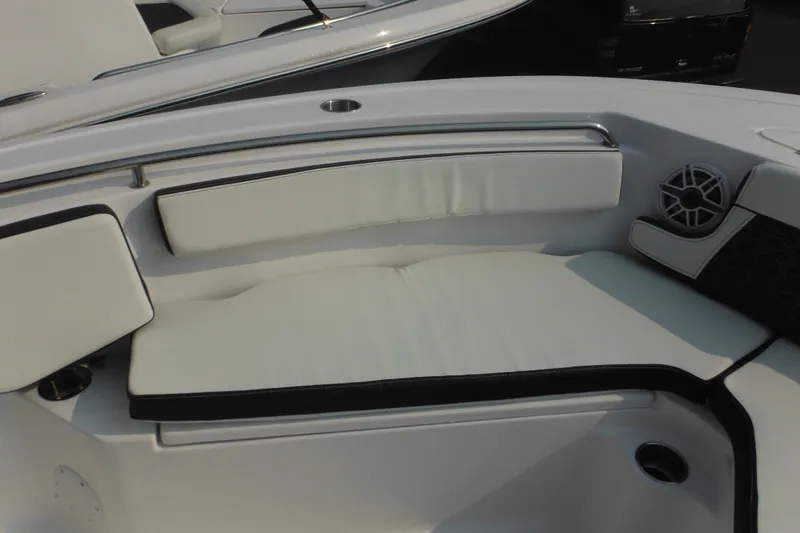Slide: The Image of 2026 Tidewater 210 LXF boat interior with cushioned seating and speaker. - 80