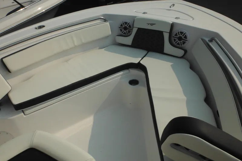 Slide: The Image of 2026 Tidewater 210 LXF boat interior with white cushioned seating and speakers. - 83