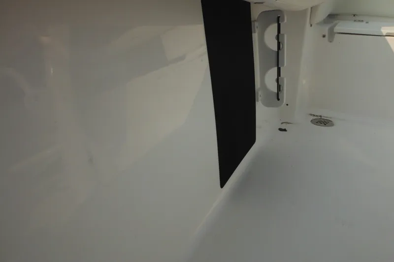 Slide: The Image of 2026 Tidewater 210 LXF interior detail with storage compartment and drain. - 84