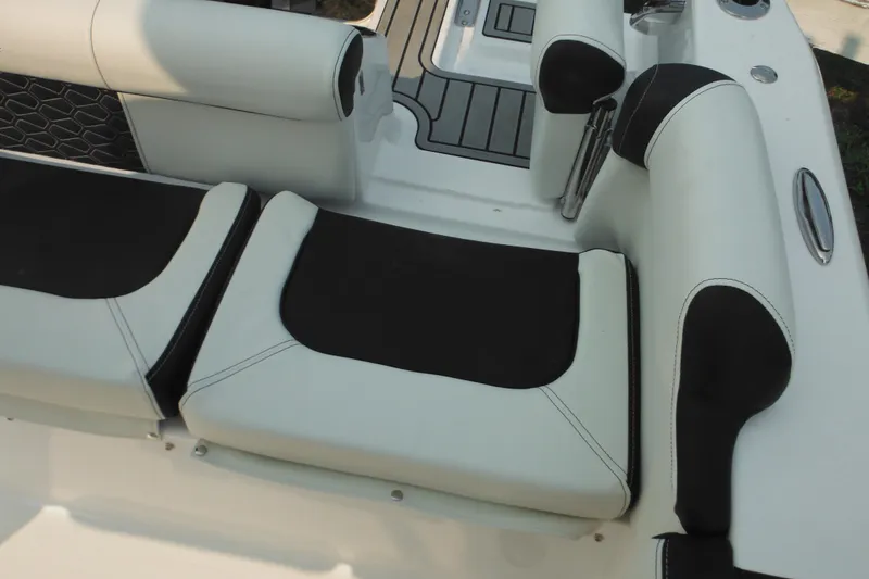 Slide: The Image of 2026 Tidewater 210 LXF boat interior with black and white cushioned seating. - 86