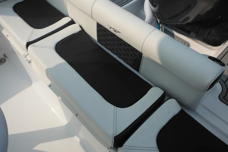 Slide: The Image of 2026 Tidewater 210 LXF boat interior seating with black and white upholstery. - 87