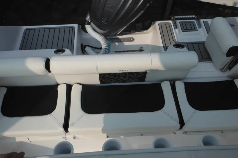 Slide: The Image of 2026 Tidewater 210 LXF boat interior with cushioned seating and sleek design. - 89