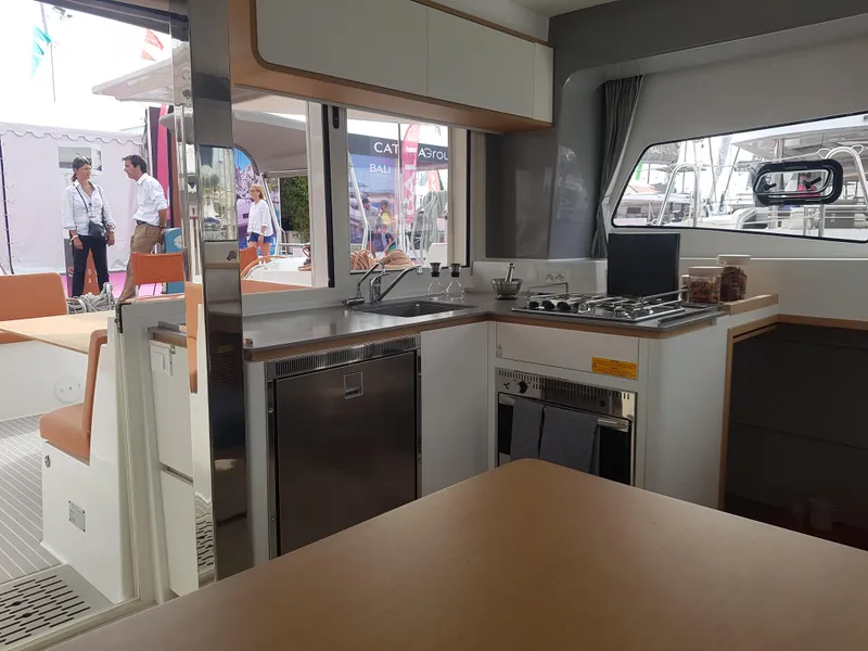Slide: The Image of Interior of 2020 Excess 12 catamaran featuring a modern kitchen and dining area. - 6