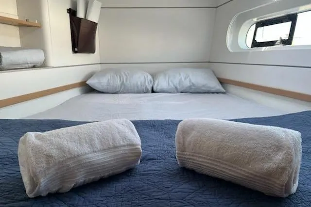 Slide: The Image of Cozy cabin interior of 2020 Excess 12 yacht with neatly arranged towels and bedding. - 8