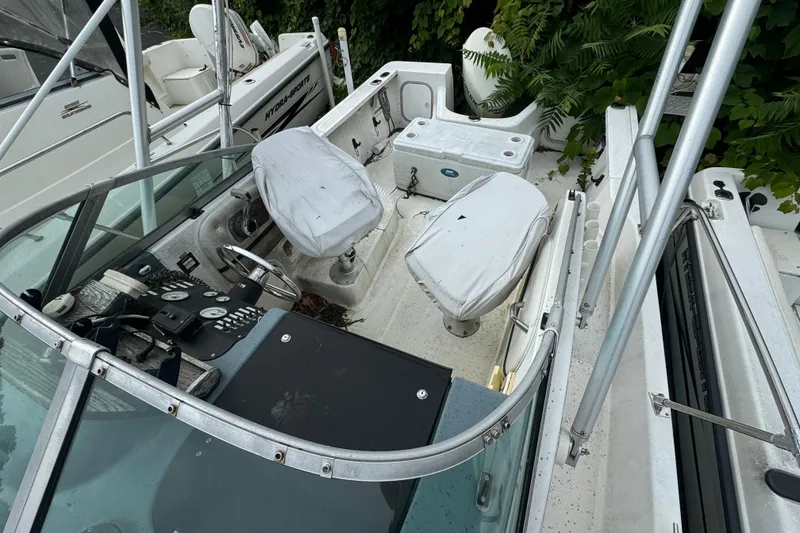 Slide: The Image of 1999 Bayliner 2102 Trophy boat interior with steering console and seating. - 5