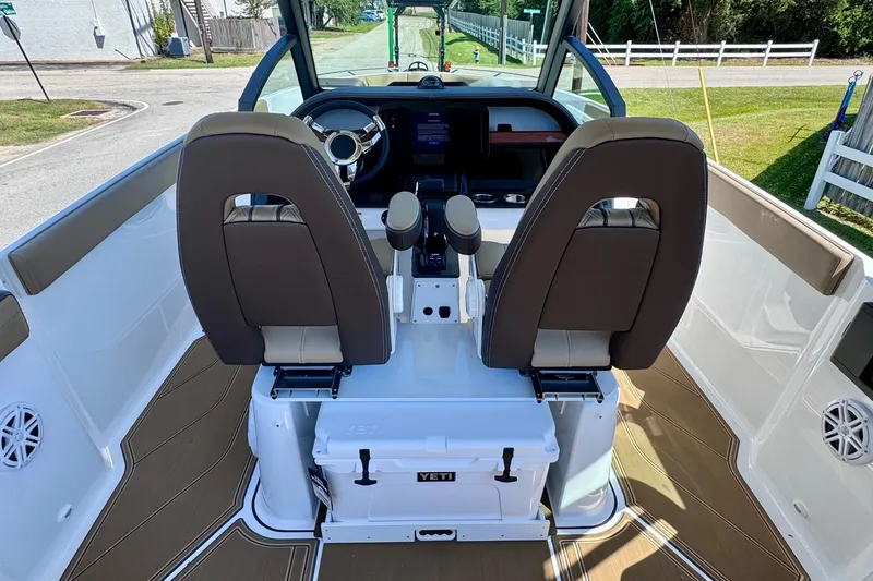 Slide: The Image of Interior view of 2026 Monterey Elite 27 OB boat cockpit with dual seats and steering wheel. - 11