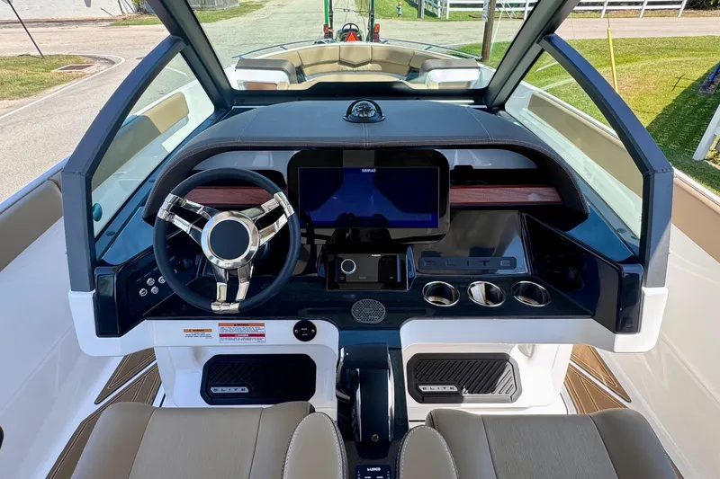 Slide: The Image of 2026 Monterey Elite 27 OB boat dashboard with modern steering wheel and digital display. - 14
