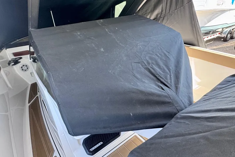 Slide: The Image of 2026 Monterey Elite 27 OB boat interior with protective cover, showcasing sleek design and modern features. - 23