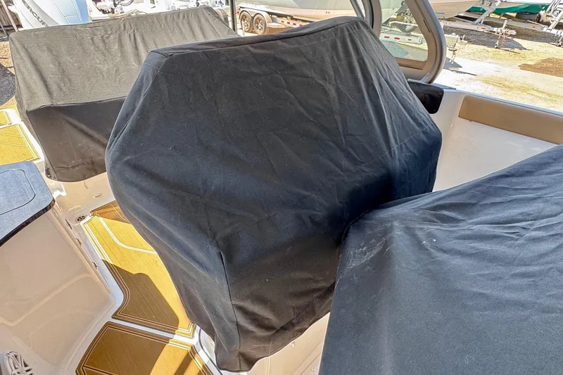 Slide: The Image of Covered seats on a 2026 Monterey Elite 27 OB boat deck. - 24