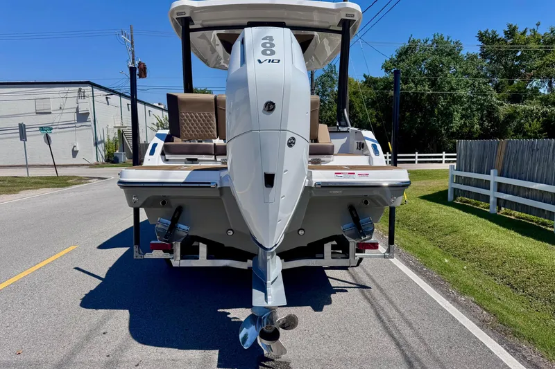Slide: The Image of 2026 Monterey Elite 27 OB boat with powerful outboard motor on a sunny street. - 3