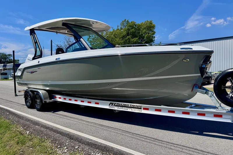 Slide: The Image of 2026 Monterey Elite 27 OB boat on trailer, parked on a sunny day. - 5