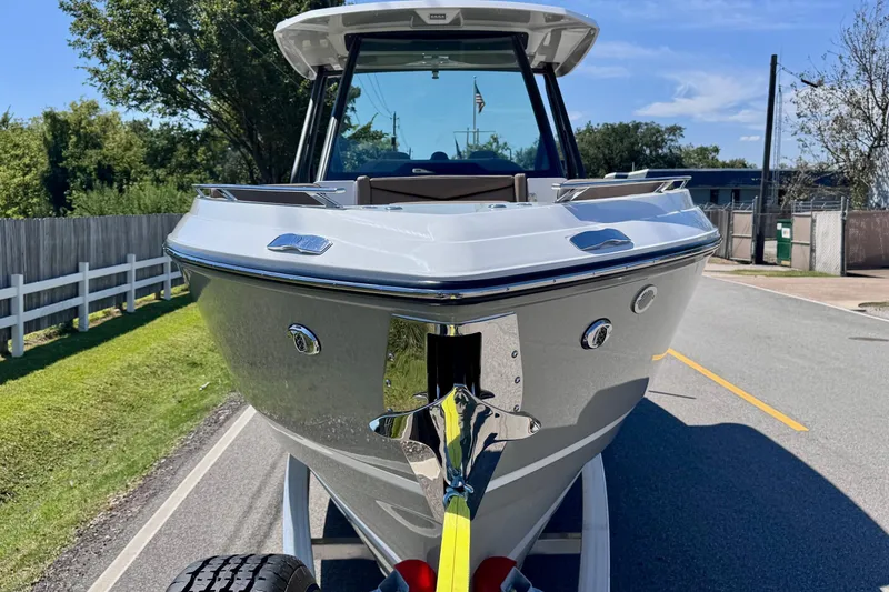 Slide: The Image of 2026 Monterey Elite 27 OB boat on trailer, parked on a sunny road. - 6