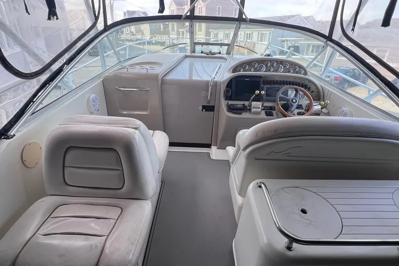 Slide: The Image of Interior of 2000 Sea Ray 290 Amberjack boat, featuring helm and seating area. - 10